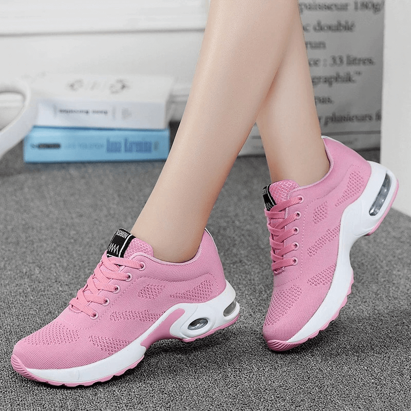 Pink breathable women's running shoes with a cushioned insole and flexible design, perfect for a comfortable, natural movement.
